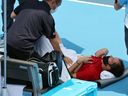 Daniil Medvedev is visited by a physio during a tennis match at the Tokyo Olympics on July 28, 2021. The Russian athlete spoke about the dangers of extreme heat for competitors.